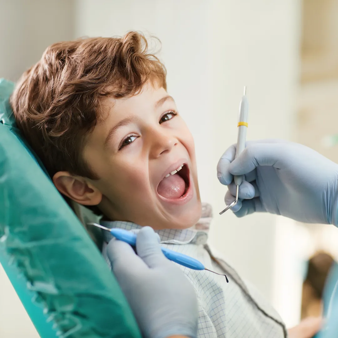 Young child smiling during a dental appointment at Noble Dental in Warrawong